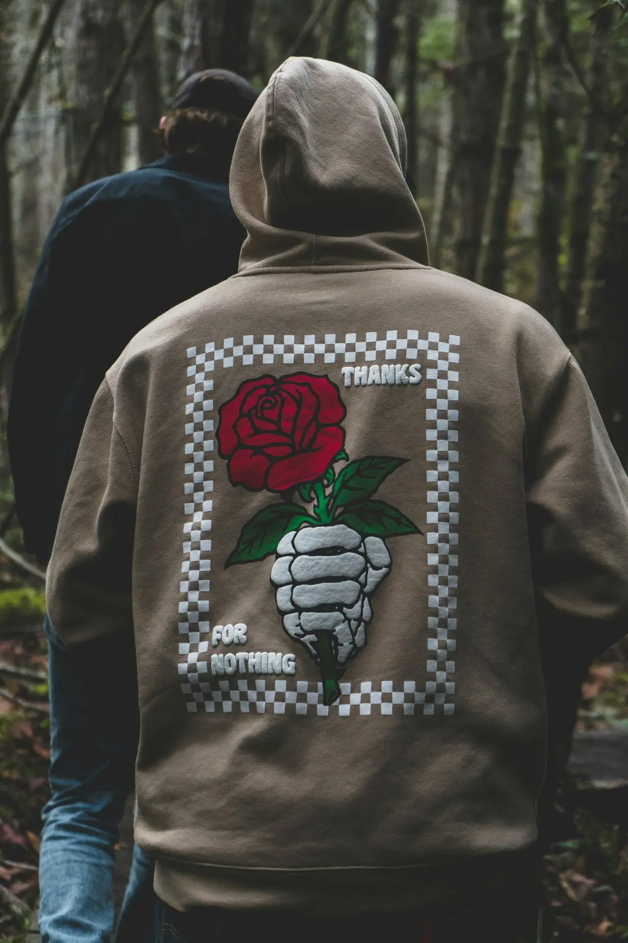a person wearing a jacket with a rose on it